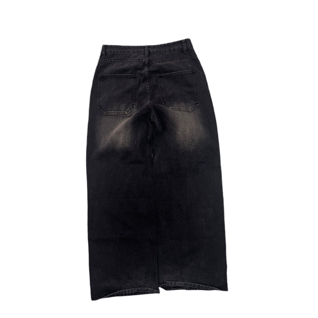 Black washed denim skirt with back pockets, shown from the back on a white background.