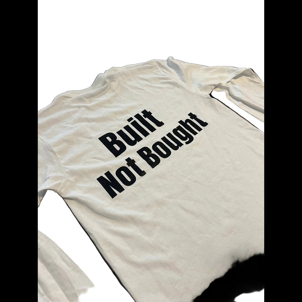 A white long-sleeve t-shirt with the phrase 'Built Not Bought' printed in bold black text across the chest, shown against a plain white background.