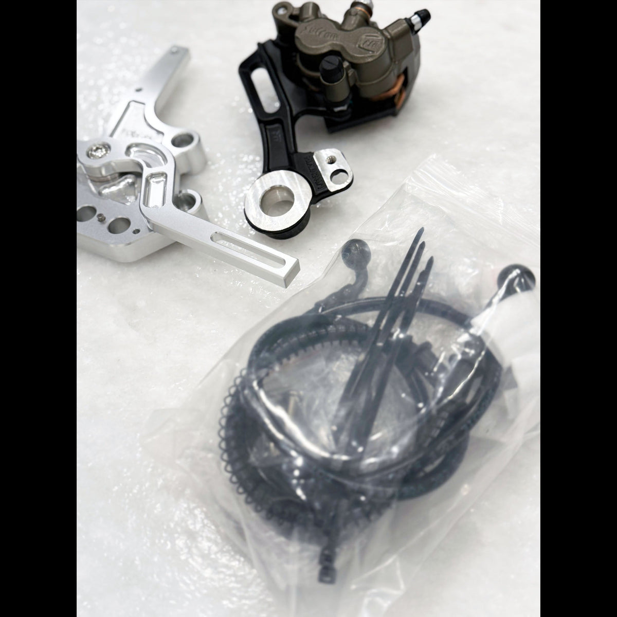 Sur-Ron and E-Ride foot brake kit with Ultra Bee calipers – close-up detail