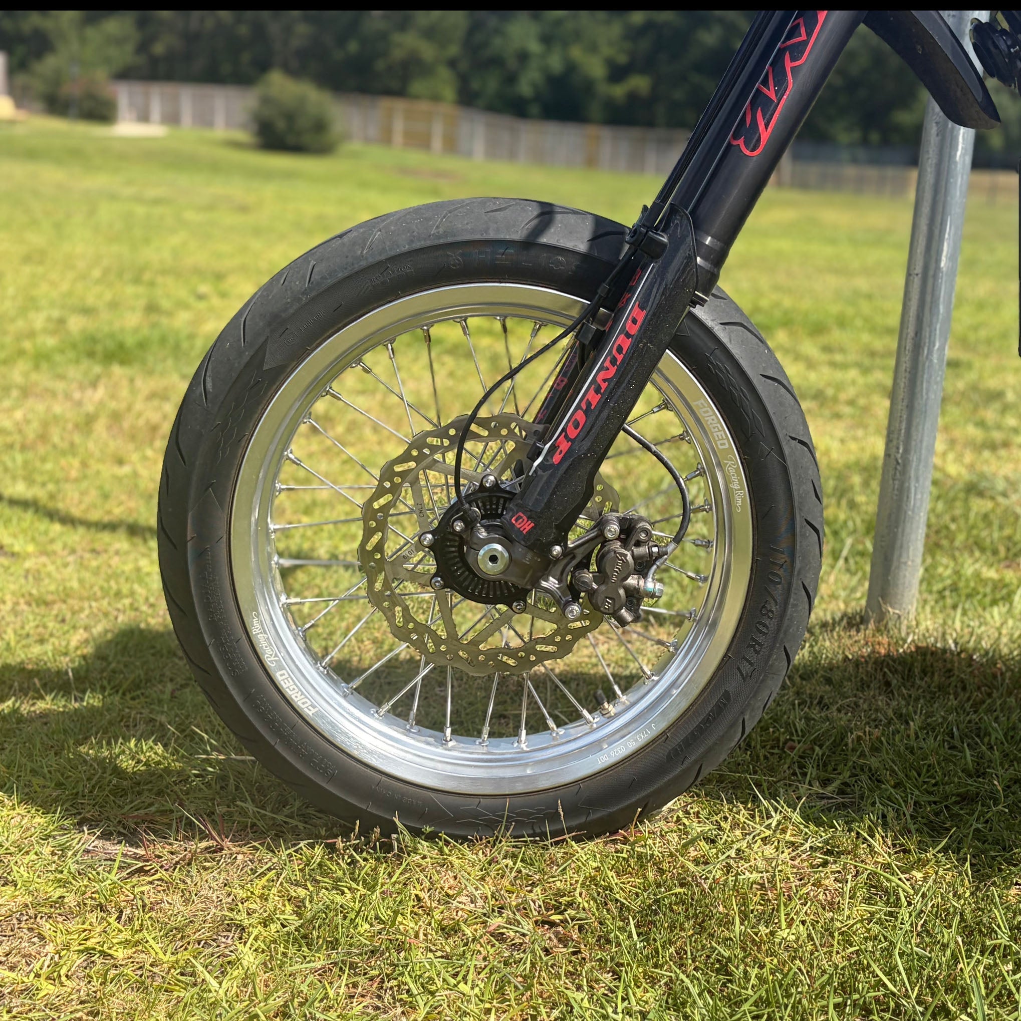 Sur-Ron Ultra Bee 17-inch supermoto wheel set in black and chrome finish – close-up detail