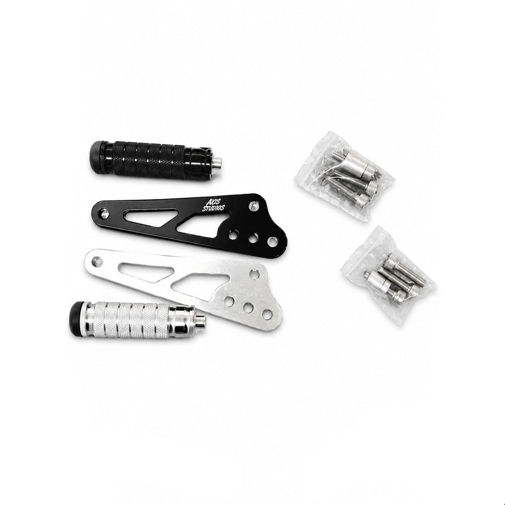 A set of motorcycle foot pegs and mounting hardware from Axis, including two black and two silver aluminum foot pegs with textured grips, shown alongside small plastic bags of mounting bolts and screws on a white background.